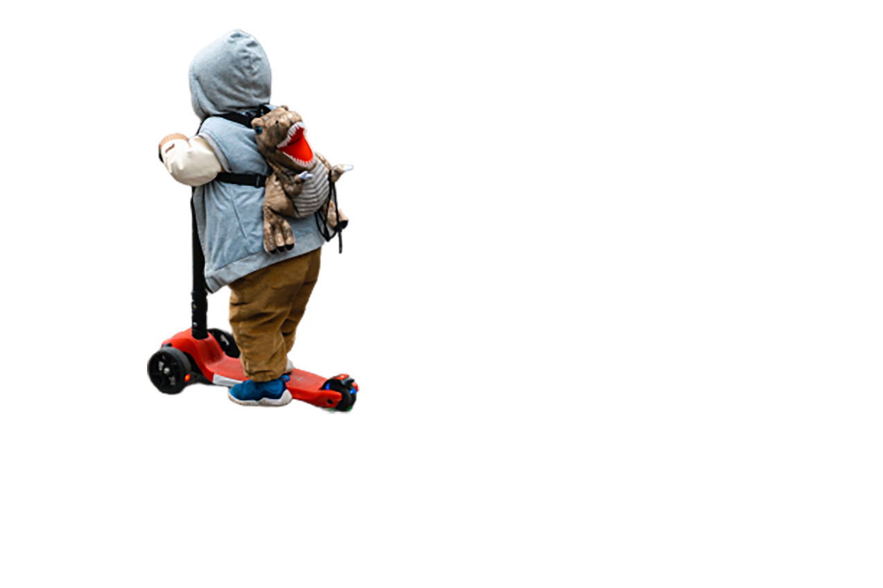 Child on a red scooter transparent background PNG