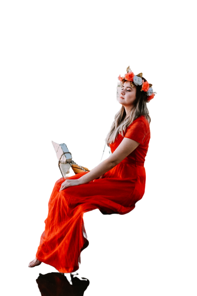 Girl sitting in red/orange dress on long chair Transparent Background PNG