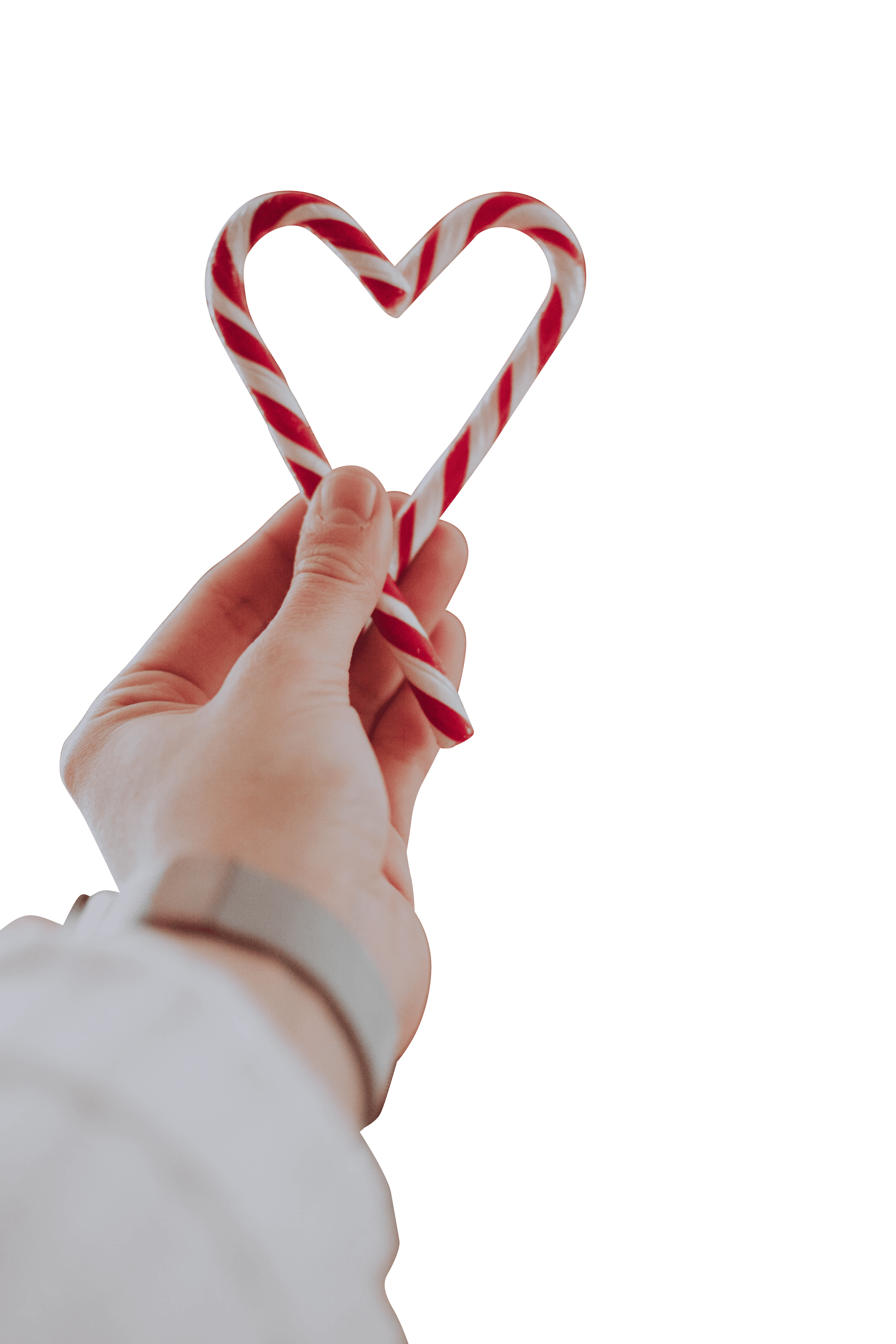 A man holding heart shape with Christmas candy canes transparent background.png